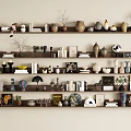 Stylish Layered Decorative Ornament Arrangement on Shelves with Vases Books Sculptures Plants and Photo Frames