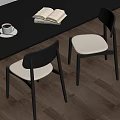 Modern Dining Chairs With Black Frame And White Padded Seats By Wooden Table