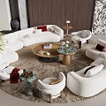 White Irregular Shaped Sofa Living Room With Round Coffee Tables Accent Chairs And Plants