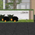 Modern Stone Feature Wall Design With Green Bushes And Building Entrance Lighting