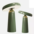 Two Green Table Lamps With Different Heights Round Tops And Gold Accent Details