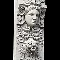Intricate Carved Stone Column With Classical Face Sculpture And Ornamental Details