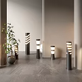 Modern Outdoor Lights with Striped Patterns Tall and Short Pillar Designs in Contemporary Courtyard