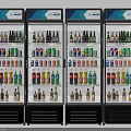 Four Commercial Beverage Refrigerators With Glass Doors And Assorted Bottled Drinks