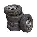 Car Tires Stacked with Silver Rims and Black Tread Patterns in Pile