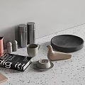 Stylish Kitchenware Collection with Marble Bowl Wooden Board Glass Bottles Metal Canisters on Light Countertop