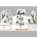 Modern Exhibition Booth With Display Screens Tables Chairs Decorative Flowers And Display Cabinets