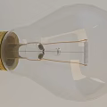 Two Transparent Incandescent Light Bulbs With Golden Bases Standing And Leaning
