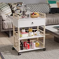 Wheeled Multi Tiered Side Table with Fruit Basket Drinks Cups and Books in Living Room