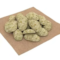 Natural Round Textured Stones Arranged in Pile on Brown Cloth Surface