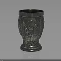 Silver Decorative Metal Cup With Intricate Carved Patterns And Ornate Base Design