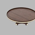 Round Dark Wood Coffee Table With Golden Trim And Intricate Carved Base