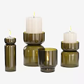 Green Glass Candle Holders With Different Sizes And Lit White Candles