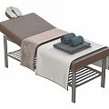 Comfortable Modern Massage Bed With Brown Beige Mattress Metal Frame And Folded Towels