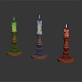 Three Ornate Candle Holders With Lit Candles Red Bases And Carved Details On Dark Surface