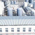 Modern Industrial Factory Building With Metal Roof Storage Tanks And Piping Systems