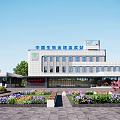Modern Office Building Exterior With Large Windows Landscaped Garden And Colorful Flower Beds