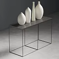 Four White Vases Arranged On Black Metal Frame Table Against Dark Gray Wall