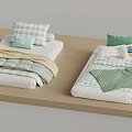Two Beds With Green And White Bedding Pillows And Blankets On Wooden Platform
