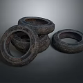 Rusty Old Car Tires Stacked Together With Worn Tread On Dark Background