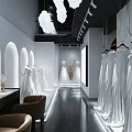Modern Bridal Shop Interior With Elegant Hanging Wedding Gowns And Full Length Mirrors
