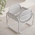 Modern White Stool With Metal Frame And Mesh Design On Wooden Floor And Green Plant