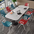 White Oval Conference Table With Laptop Documents Cup And Colorful Chairs In Modern Meeting Room