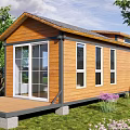 Wooden Cabin Vacation Rental With Front Deck Large Windows And Green Lawn Surrounded By Trees
