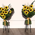 Floral Display With Sunflowers Green Wrapping And Orange White Ribbons On Black Tripods