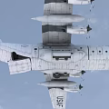 U.S. Air Force Fighter Jet Flying High in Clouds with Propeller Engines and Military Markings