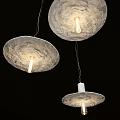 Modern Textured White Pendant Lights With Visible Bulbs Hanging In Black Background