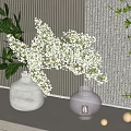 White Vase with White Flowers Green Leaves Glass Candle Holder Gold Balls Against Striped Wall