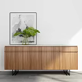 Modern Wooden Sideboard With Natural Finish Green Plant And Abstract Painting Black Slim Legs