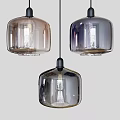 Three Modern Glass Pendant Lights With Transparent Shade And Metallic Base Design