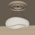 Pleated Beige Fabric Chandelier With Curved Design Hanging From Ceiling With Circular Trim