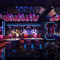 Luxury KTV Room Interior With Colorful Lighting LED Screen Sofa Seating And Balloon Decorations