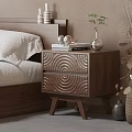 Wooden Nightstand with Circular Texture Drawers Books Headphones Small Plant Vase in Modern Bedroom