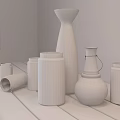 Ceramic Vessels In Various Shapes On Wooden Table With Gray Textured Wall And Natural Light