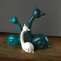 Snail Shaped Decorative Ornament Set With Green And White Design On Wooden Tabletop