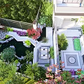 Beautiful Water Fountain in Garden Surrounded by Lush Greenery Stone Pathways and Colorful Flowers