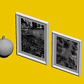 Two White Picture Frames With Black And White Photos And Yellow Spherical Object Dark Background