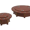 Round Brown Dining Tables In Two Different Sizes With Gold Accents And Circular Recesses