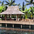 Landscape Pavilion with Thatch Roof on Wooden Deck Surrounded by Palm Trees Over Water