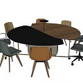 Round Conference Table With Mixed Black And Wooden Surface And Various Office Chairs