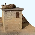 Park Landscape Featuring Stone Basin on Brick Pedestal with Fallen Leaves and Paved Path