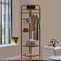 Gold Multi Tiered Clothes Rack With Coat Hat Bag And Decor In Bright Indoor Space