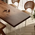 Wooden Dining Table Set With Fan Shaped Chairs Pinecone Decor And Green Plant In Bright Room