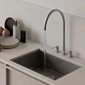 Stainless Steel Kitchen Faucet with Water Flowing into Modern Sink and Ceramic Items on Countertop