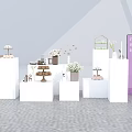 Modern Exhibition Booth Design With White Display Tables Product Racks Green Plants And Signage