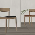 Simple Design Wooden Dining Chairs With Black Brown Seats And Green Plant In Light Space